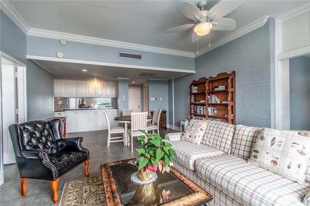 living room with a textured ceiling, ceiling fan, and crown molding