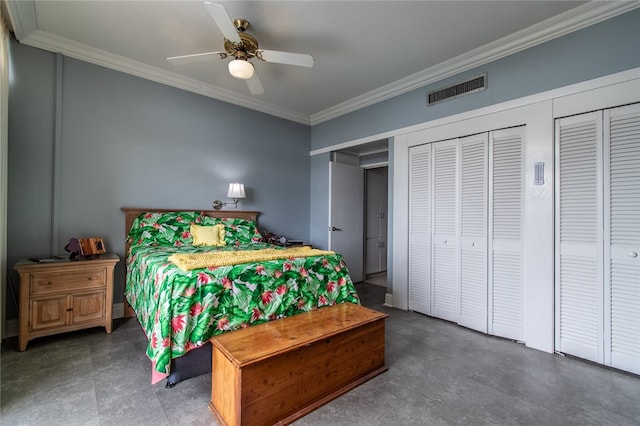 bedroom with ceiling fan, two closets, and ornamental molding