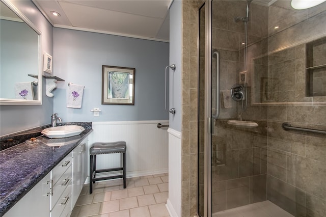 bathroom featuring walk in shower, vanity, and tile patterned floors