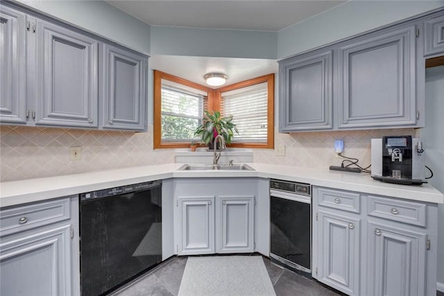 7506 Bistineau Dr, Corpus Christi, TX 78413 - kitchen with black dishwasher, tasteful backsplash, light countertops, and dark tile patterned flooring