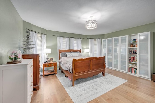 7506 Bistineau Dr, Corpus Christi, TX 78413 - bedroom featuring light wood finished floors and a chandelier