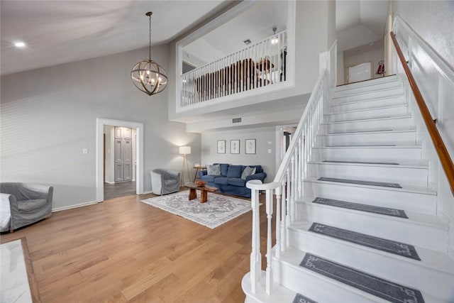 7506 Bistineau Dr, Corpus Christi, TX 78413 - staircase with high vaulted ceiling, wood finished floors, and a chandelier