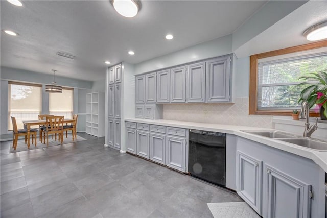 7506 Bistineau Dr, Corpus Christi, TX 78413 - kitchen featuring dishwasher, light countertops, tasteful backsplash, recessed lighting, and decorative light fixtures