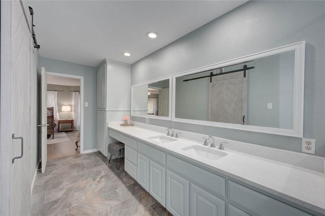 7506 Bistineau Dr, Corpus Christi, TX 78413 - ensuite bathroom with double vanity, stone finish flooring, and recessed lighting