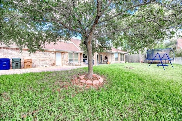 7506 Bistineau Dr, Corpus Christi, TX 78413 - fenced backyard featuring a trampoline and a patio