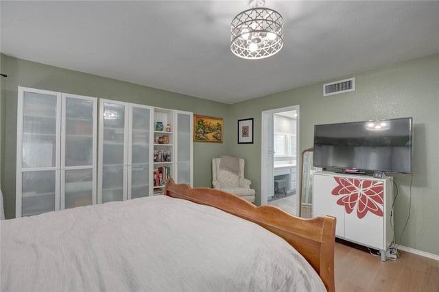 7506 Bistineau Dr, Corpus Christi, TX 78413 - bedroom with light wood-style flooring and connected bathroom