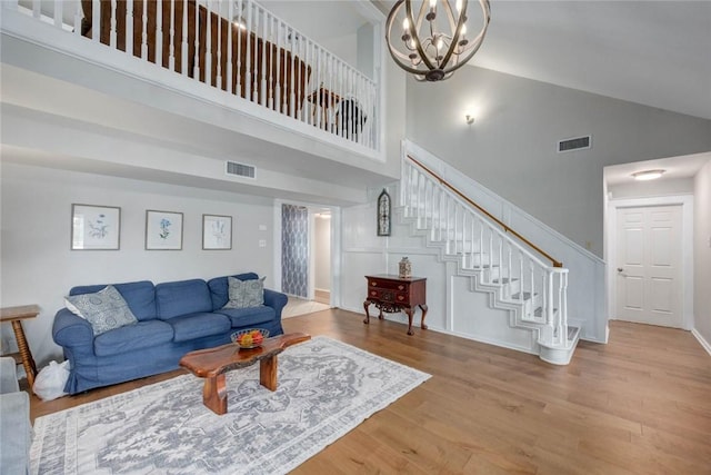 7506 Bistineau Dr, Corpus Christi, TX 78413 - living area with wood finished floors, high vaulted ceiling, stairs, and a chandelier