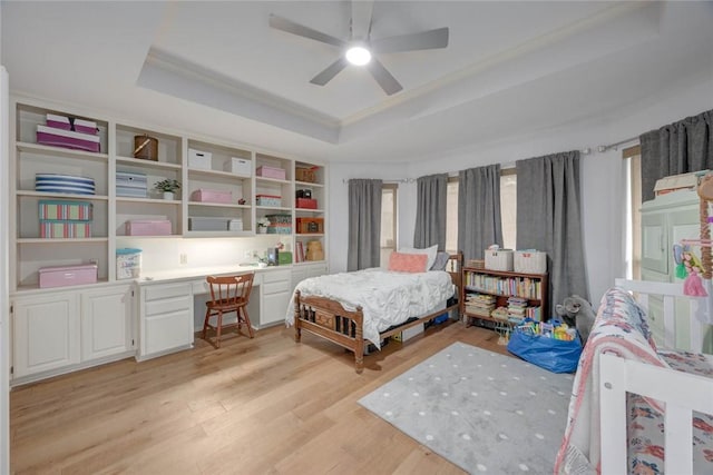7506 Bistineau Dr, Corpus Christi, TX 78413 - bedroom with a raised ceiling, built in desk, light wood-style flooring, multiple windows, and ornamental molding