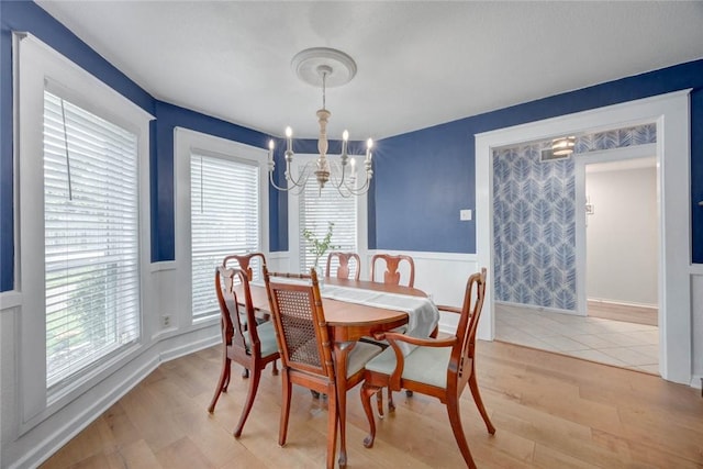7506 Bistineau Dr, Corpus Christi, TX 78413 - dining space featuring a chandelier, wainscoting, light wood finished floors, and a decorative wall