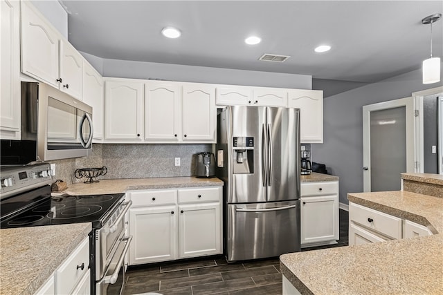 kitchen with white cabinetry, decorative backsplash, stainless steel appliances, and hanging light fixtures