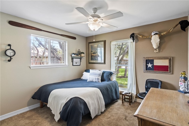 carpeted bedroom with multiple windows and ceiling fan