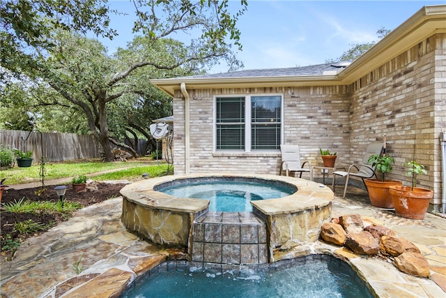 view of swimming pool with an in ground hot tub and a patio area