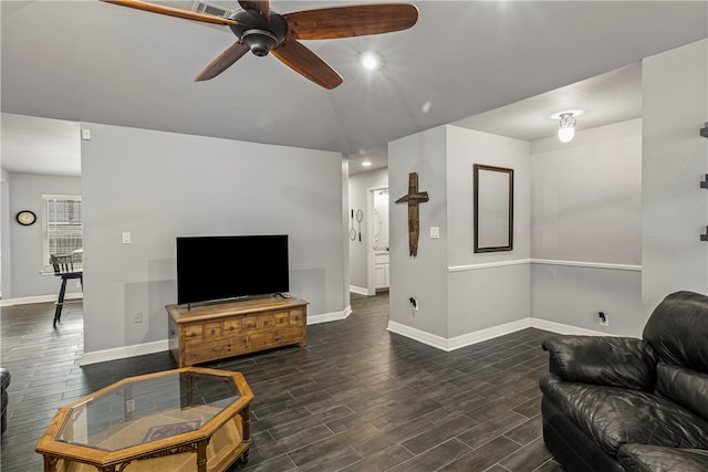 living room with ceiling fan and dark hardwood / wood-style floors