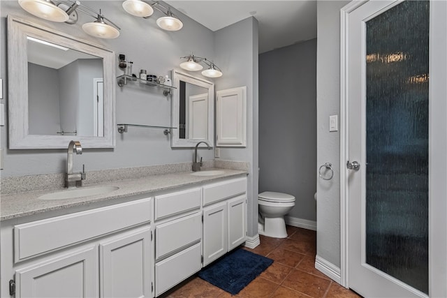 bathroom with tile patterned floors, vanity, and toilet