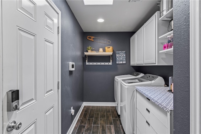 laundry room featuring cabinets, washer and dryer, and dark hardwood / wood-style floors