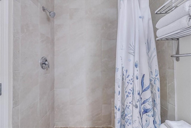 full bath featuring tiled shower