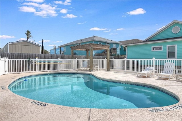 community pool featuring fence, a pergola, and a patio