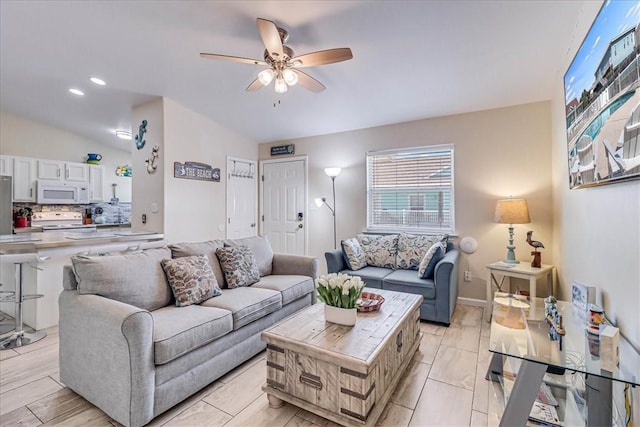 living room featuring ceiling fan, light wood-type flooring, and recessed lighting