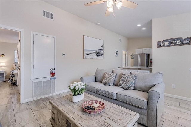 living area with recessed lighting, visible vents, ceiling fan, and baseboards