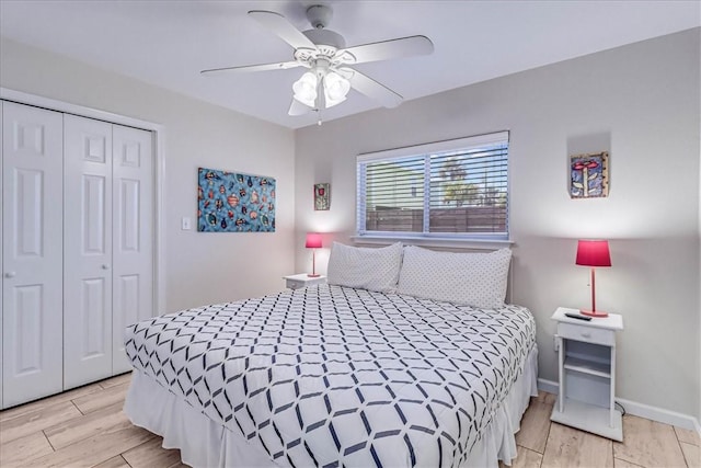 bedroom with ceiling fan, baseboards, a closet, and wood finish floors