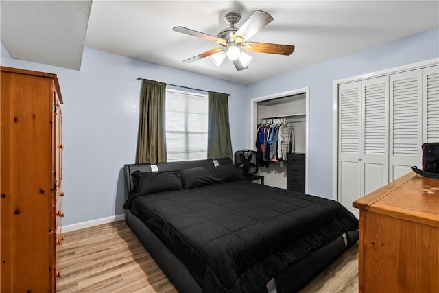 607 E 11th St, Bishop, TX 78343 - bedroom with light wood-type flooring, two closets, baseboards, and ceiling fan