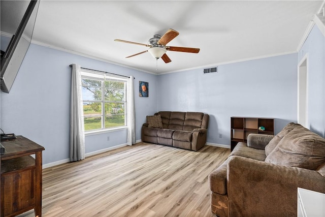607 E 11th St, Bishop, TX 78343 - living area with ornamental molding, light wood-style floors, ceiling fan, and baseboards