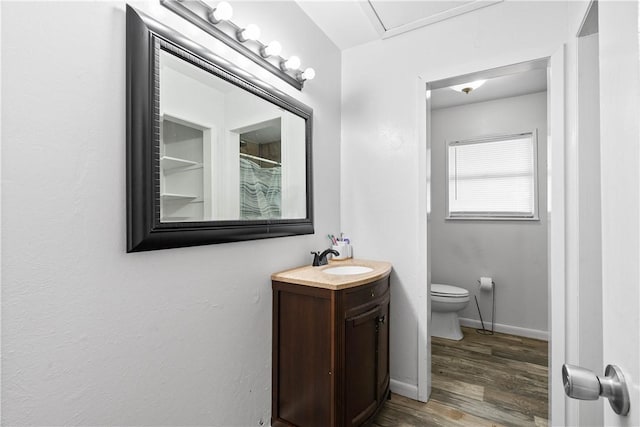 607 E 11th St, Bishop, TX 78343 - bathroom featuring vanity, toilet, wood finished floors, baseboards, and a shower with shower curtain