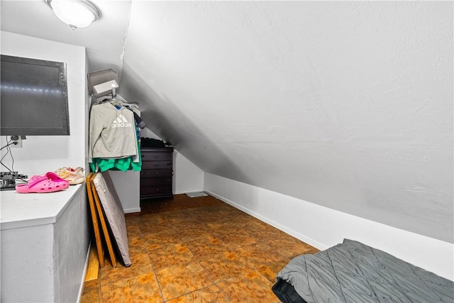 607 E 11th St, Bishop, TX 78343 - bedroom with vaulted ceiling and baseboards