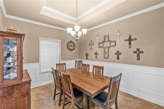 2004 Chesapeake Bay Dr, Portland, TX 78374 - dining space featuring a tray ceiling, a decorative wall, a wainscoted wall, ornamental molding, and a chandelier