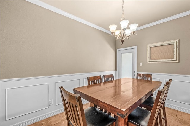 2004 Chesapeake Bay Dr, Portland, TX 78374 - dining space with a chandelier, ornamental molding, a decorative wall, light tile patterned floors, and wainscoting
