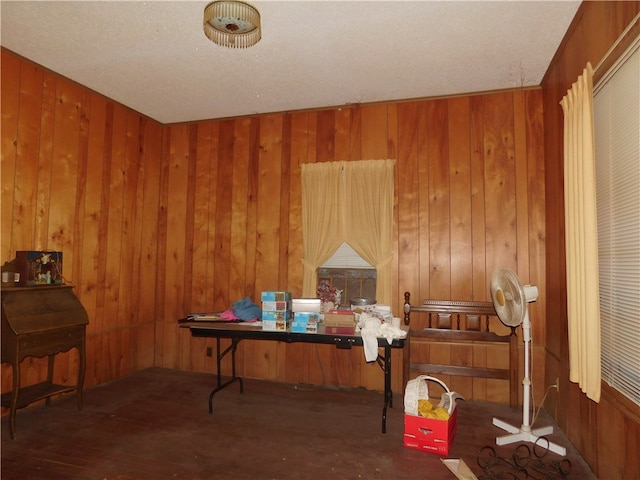 miscellaneous room featuring dark wood-type flooring and wooden walls