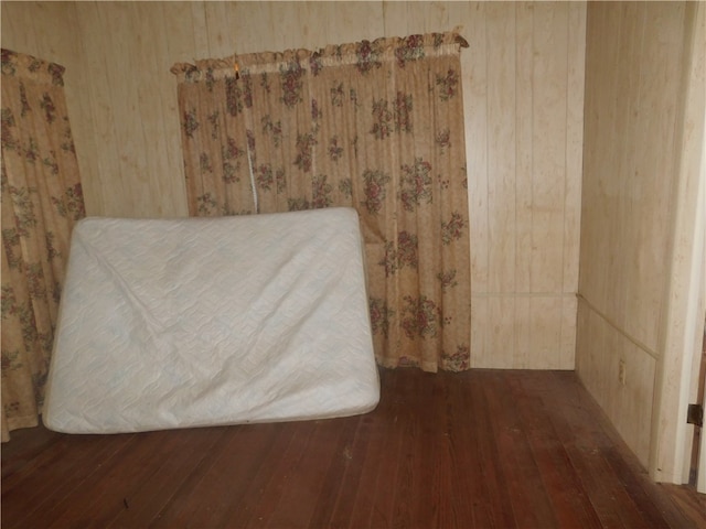 interior details featuring wood walls and wood-type flooring