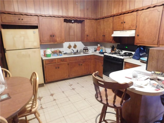 kitchen featuring white appliances and sink