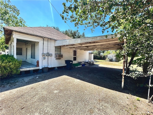 view of side of home with a carport