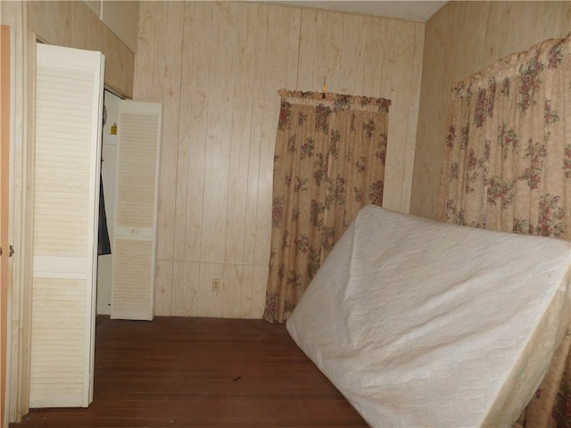 bedroom with dark wood-type flooring