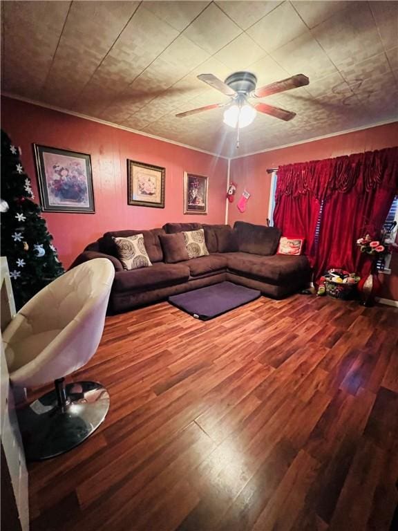 living room featuring hardwood / wood-style flooring, ceiling fan, and crown molding