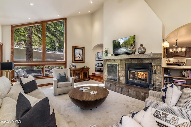 2010 Vermont Rd E, Vail, CO 81657 - living room with arched walkways, a tile fireplace, a chandelier, recessed lighting, and high vaulted ceiling