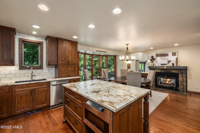 2010 Vermont Rd E, Vail, CO 81657 - kitchen with appliances with stainless steel finishes, dark wood-style flooring, a chandelier, a kitchen island, and decorative light fixtures