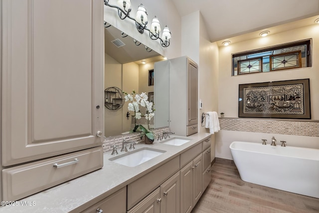 2010 Vermont Rd E, Vail, CO 81657 - full bathroom featuring wood finished floors, double vanity, and a freestanding tub