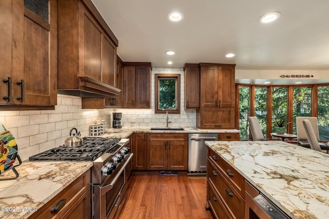 2010 Vermont Rd E, Vail, CO 81657 - kitchen with stainless steel appliances, dark wood-style flooring, light stone counters, tasteful backsplash, and recessed lighting