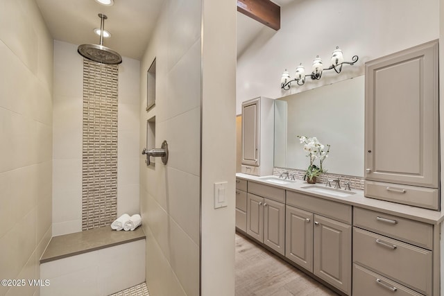 2010 Vermont Rd E, Vail, CO 81657 - bathroom featuring double vanity, tiled shower, and wood finished floors