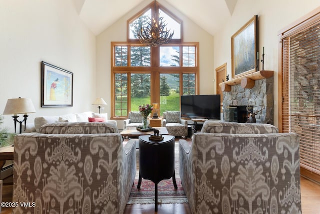 111 Club Cottage Dr, Edwards, CO 81632 - living room with wood finished floors, high vaulted ceiling, a stone fireplace, and a chandelier