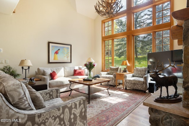 111 Club Cottage Dr, Edwards, CO 81632 - living area featuring a chandelier, wood finished floors, and high vaulted ceiling