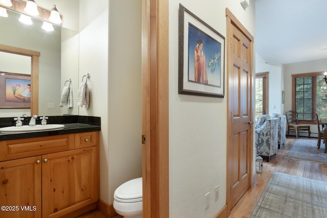 111 Club Cottage Dr, Edwards, CO 81632 - bathroom featuring vanity, wood finished floors, and baseboard heating