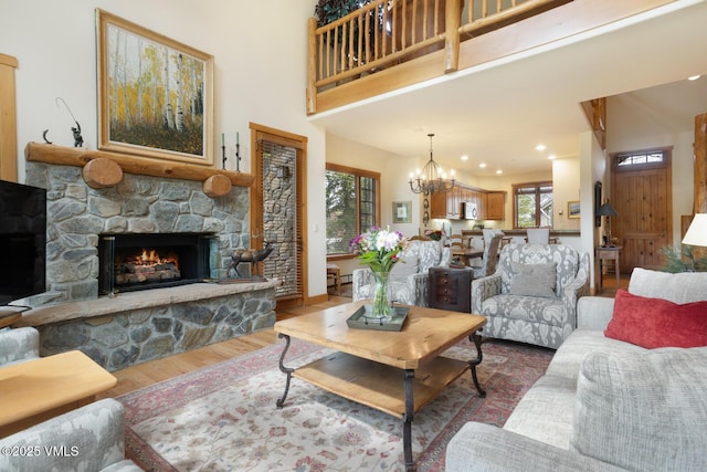 111 Club Cottage Dr, Edwards, CO 81632 - living room featuring a stone fireplace, wood finished floors, a chandelier, and recessed lighting