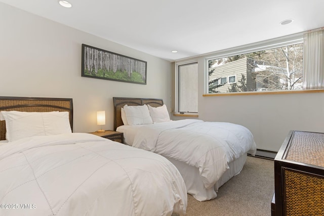 carpeted bedroom with multiple windows, baseboard heating, and recessed lighting