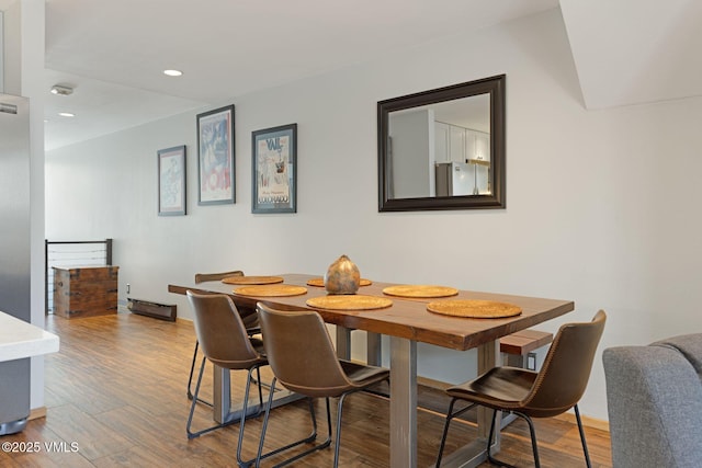 dining space featuring wood finished floors and recessed lighting