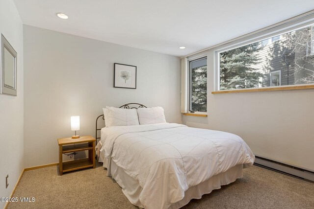 carpeted bedroom with baseboard heating, recessed lighting, and baseboards