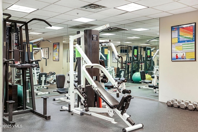 gym featuring a paneled ceiling and visible vents