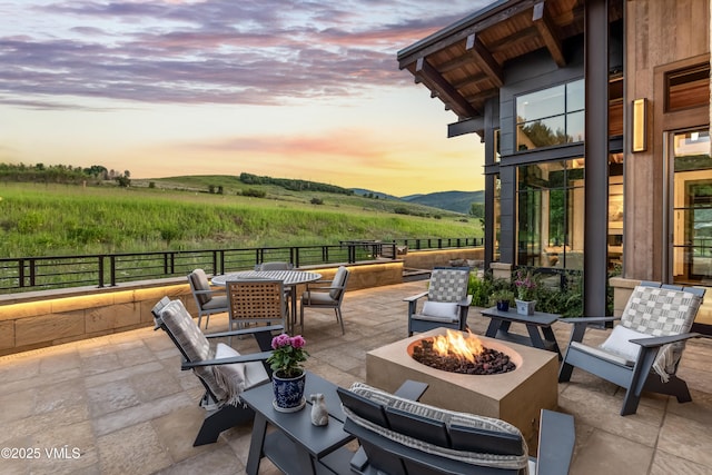 455 Old Creamery Rd, Edwards, CO 81632 - patio terrace at dusk featuring a fire pit, a patio, a rural view, a mountain view, and outdoor dining space